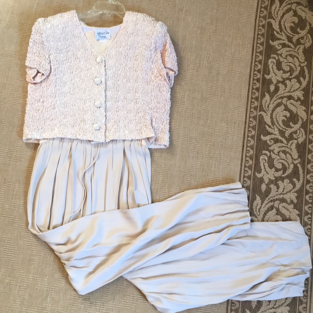 Ivory crushed jacket over jumpsuit.